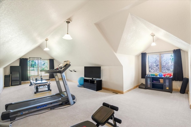 workout area with a textured ceiling, vaulted ceiling, and carpet flooring