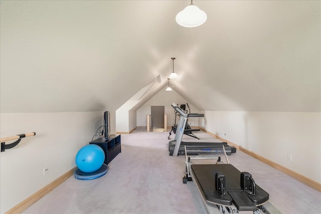 workout room with light carpet and lofted ceiling