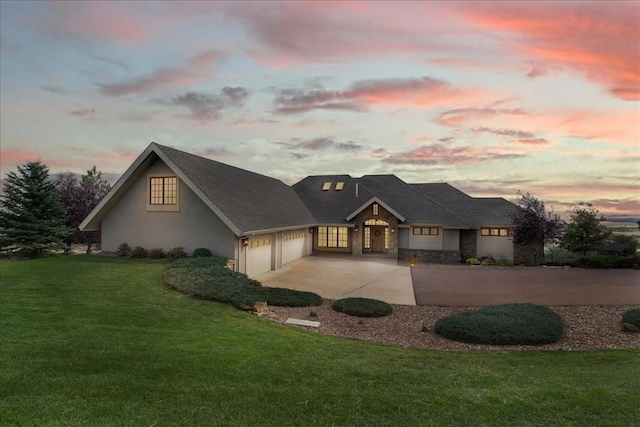 view of front facade with a lawn and a garage