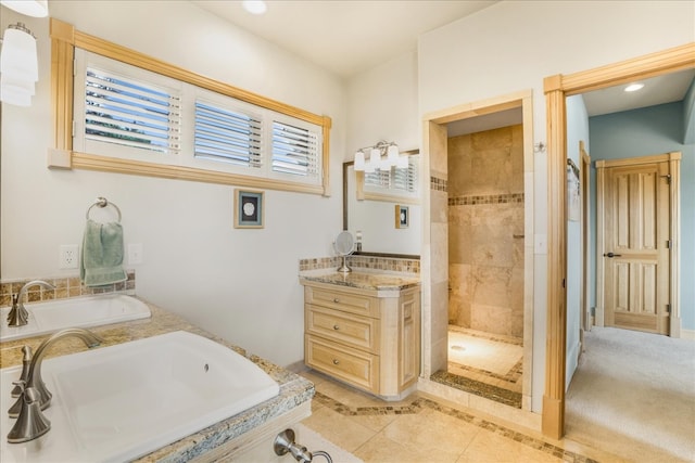 bathroom featuring tiled shower and vanity