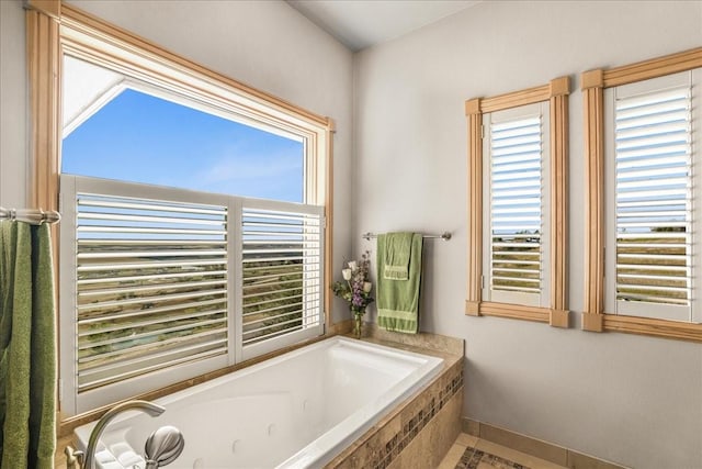 bathroom featuring a jetted tub and baseboards