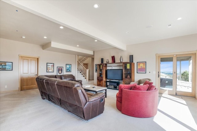 living area featuring beamed ceiling, recessed lighting, stairs, visible vents, and light colored carpet