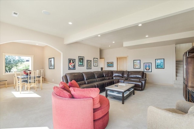 living room with recessed lighting, arched walkways, and light colored carpet