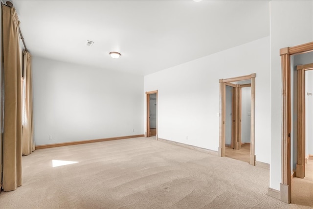 spare room with light colored carpet