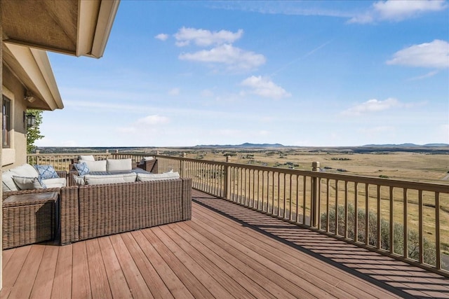 wooden deck featuring a mountain view and an outdoor hangout area