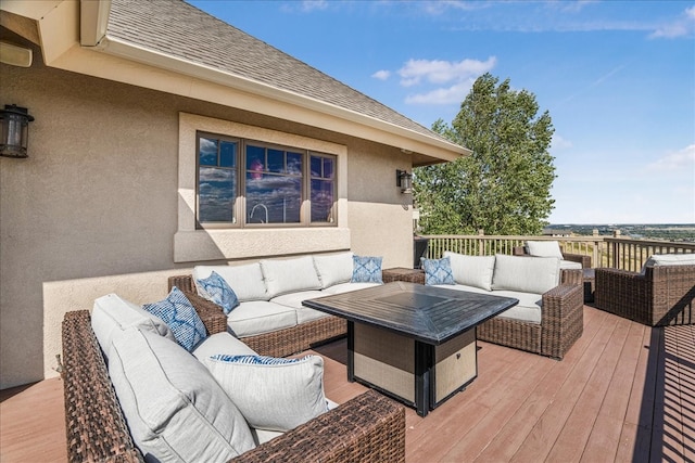 deck with an outdoor living space with a fire pit