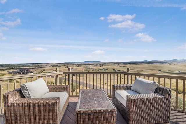 wooden deck featuring a rural view and a mountain view
