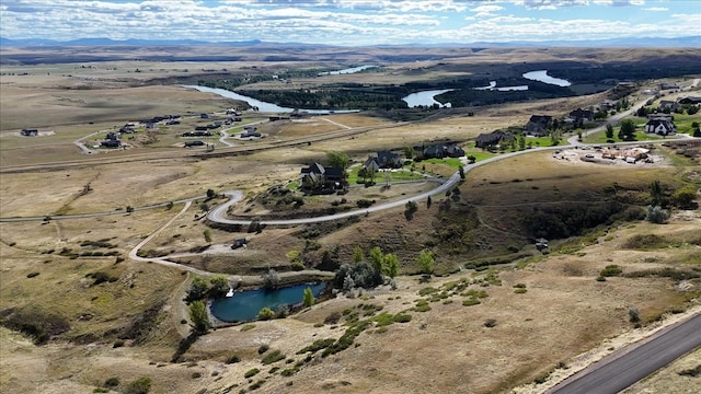 aerial view featuring a water and mountain view