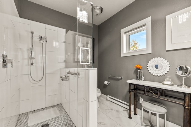 bathroom featuring a tile shower, vanity, and toilet