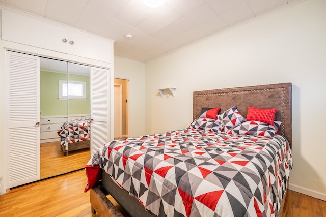 bedroom with wood-type flooring and crown molding