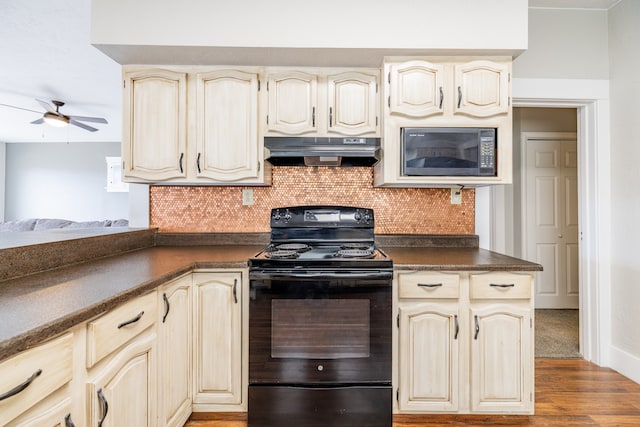 kitchen featuring backsplash, black electric range, ceiling fan, hardwood / wood-style flooring, and cream cabinets