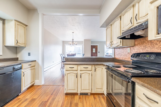 kitchen with light wood-type flooring, a chandelier, tasteful backsplash, black appliances, and decorative light fixtures