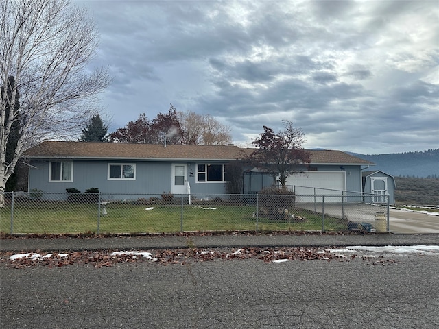 ranch-style home with a front yard and a garage