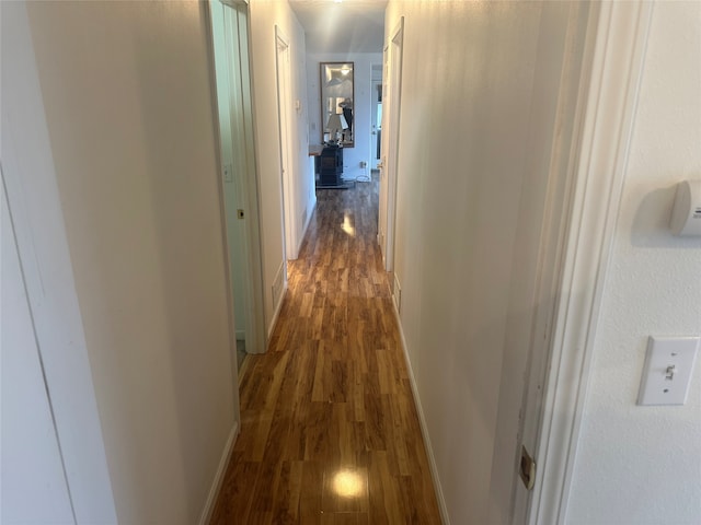 hallway with dark wood-type flooring