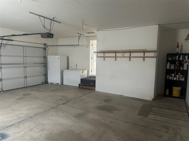 garage with white fridge and a garage door opener