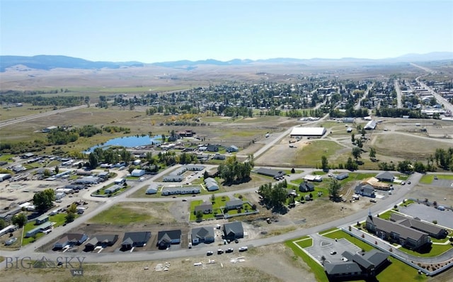 drone / aerial view with a water and mountain view