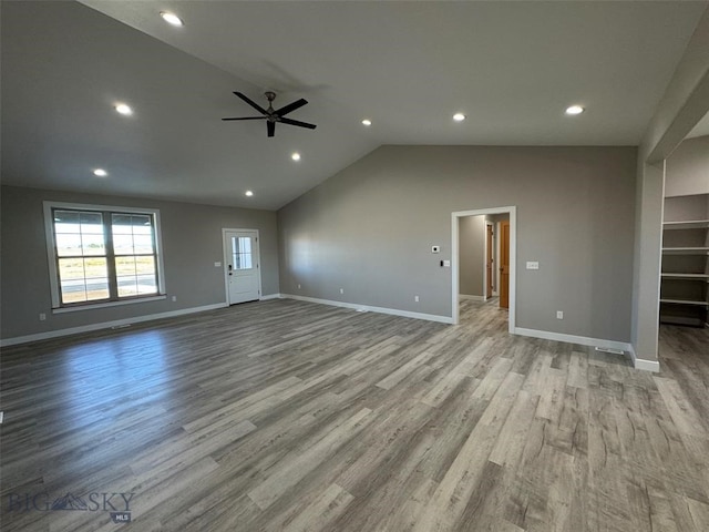 unfurnished living room with light wood-type flooring, lofted ceiling, and ceiling fan