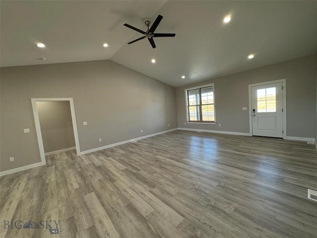 interior space featuring ceiling fan, lofted ceiling, and light hardwood / wood-style floors