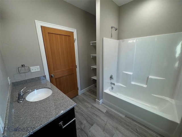 bathroom featuring shower / bathtub combination, vanity, and hardwood / wood-style flooring