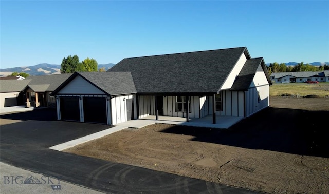 view of front of property with a mountain view and a garage