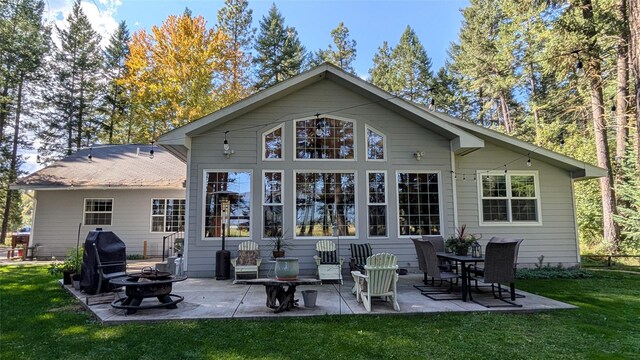 view of property exterior with a garage, a lawn, and an outdoor structure