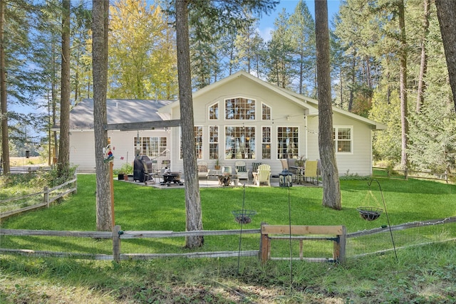 rear view of house featuring a yard, a patio, and fence