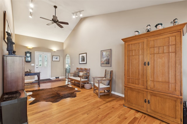 sitting room with ceiling fan, track lighting, light hardwood / wood-style floors, and high vaulted ceiling