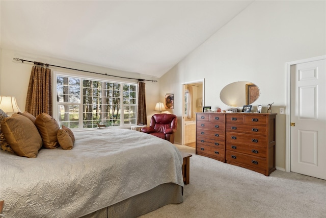 carpeted bedroom with high vaulted ceiling and connected bathroom