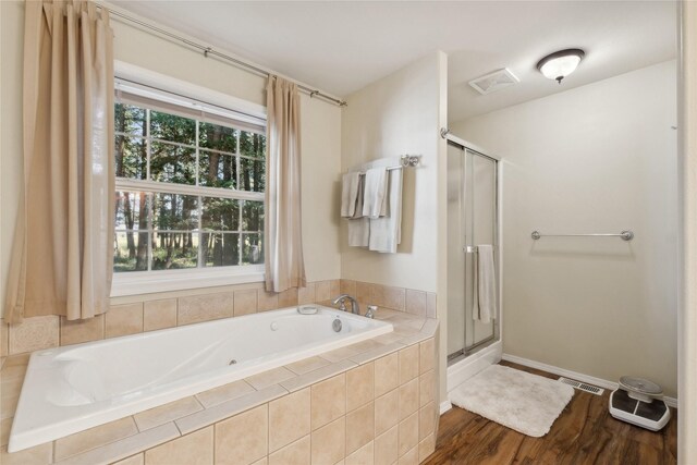 bathroom featuring shower with separate bathtub, hardwood / wood-style flooring, and vanity