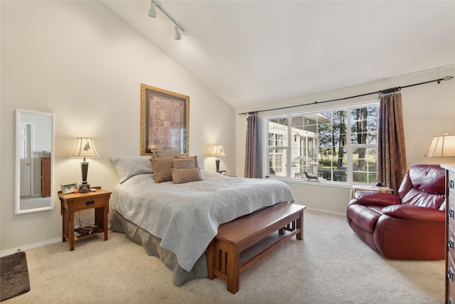 bedroom with baseboards, light colored carpet, and track lighting