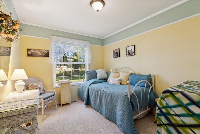 carpeted bedroom with ornamental molding