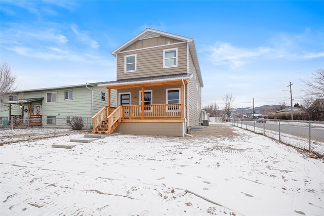 view of front of property with covered porch and central air condition unit