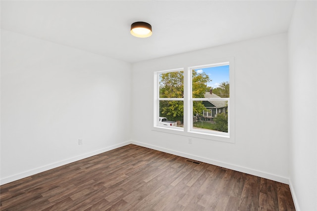 empty room with dark hardwood / wood-style floors