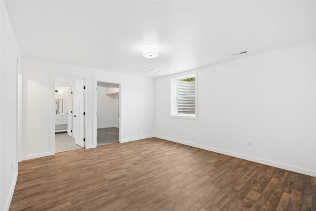 spare room with dark hardwood / wood-style flooring