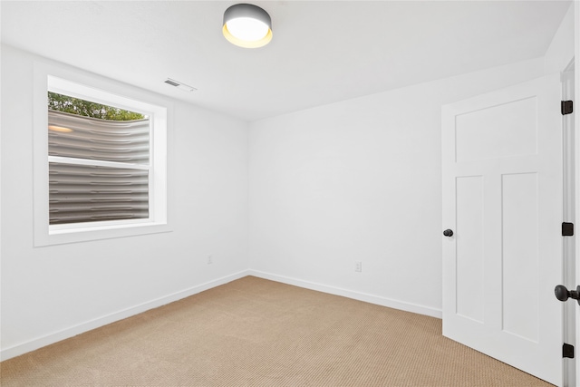 empty room featuring light carpet