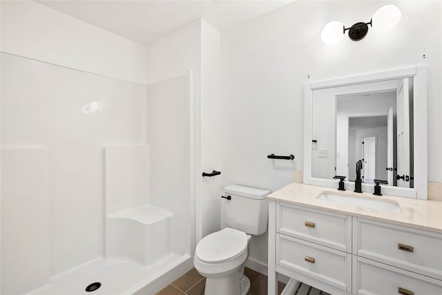 bathroom featuring walk in shower, vanity, toilet, and tile patterned flooring