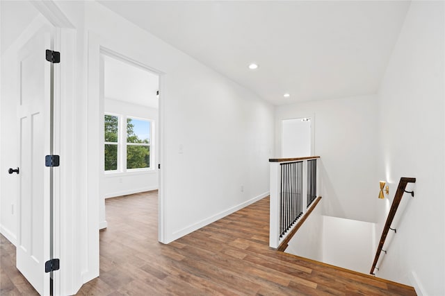 hall with hardwood / wood-style flooring