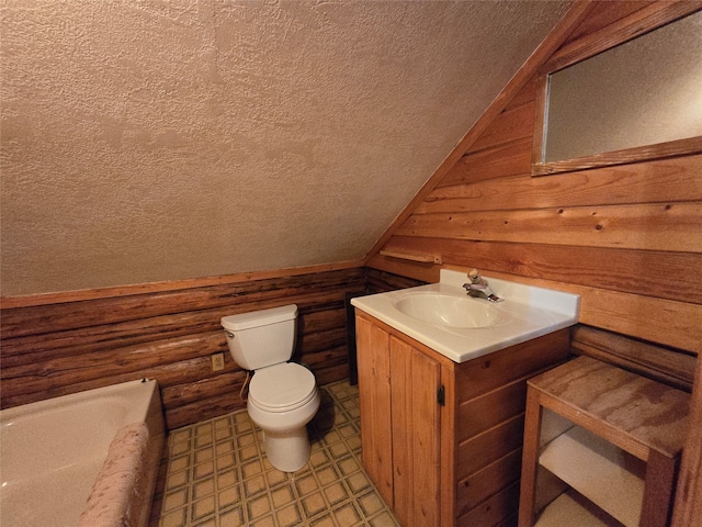 bathroom featuring vanity, a textured ceiling, lofted ceiling, a bath, and toilet