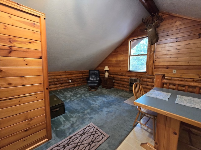 additional living space with dark carpet, lofted ceiling with beams, and wood walls