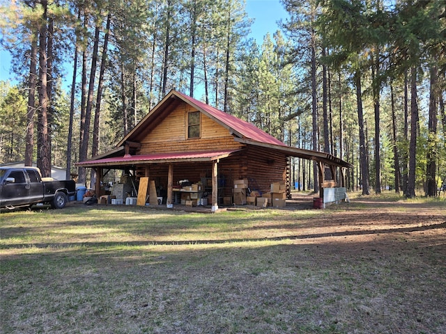 rear view of property featuring a yard