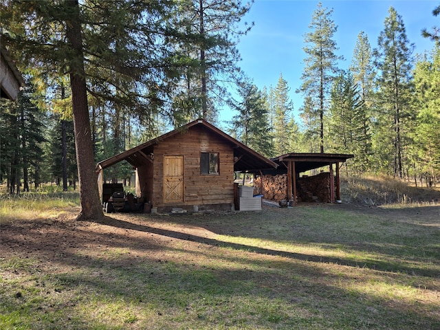 view of side of property with a lawn and a carport