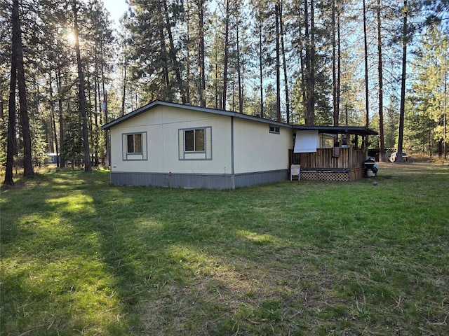 view of side of home with a lawn