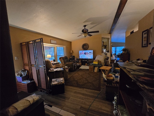 living room featuring ceiling fan, lofted ceiling with beams, and dark hardwood / wood-style flooring