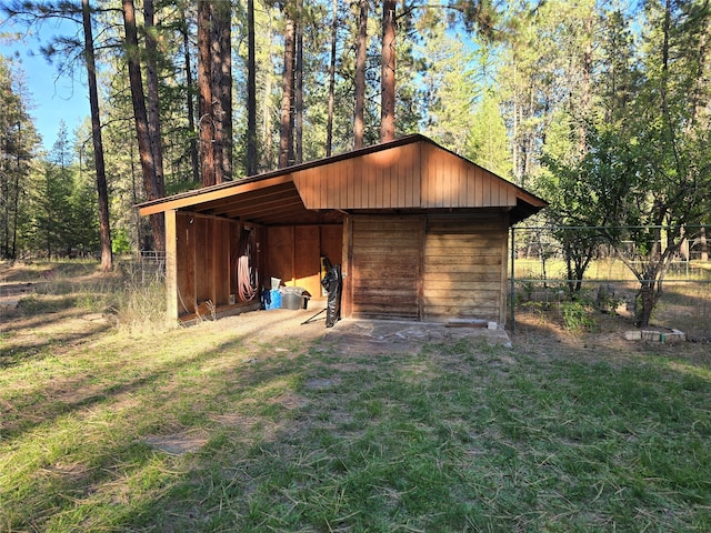 view of outbuilding with a yard