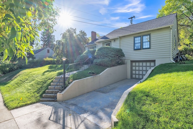 view of front of home featuring a garage and a front lawn