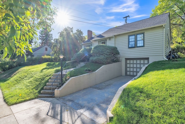 view of front of house featuring a front yard, stairway, roof with shingles, concrete driveway, and an attached garage