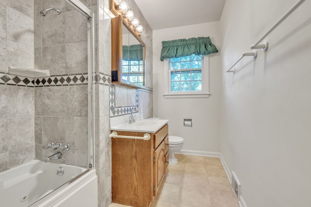 bathroom with vanity, toilet, baseboards, tile patterned floors, and shower / bathtub combination