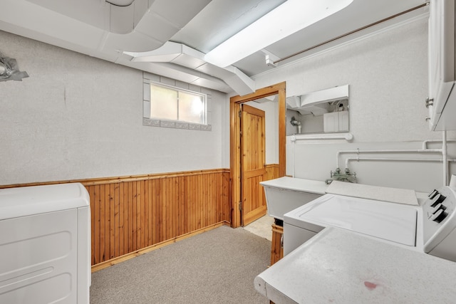 home office with light carpet, wood walls, and washer / dryer