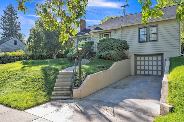 view of front of home with an attached garage, driveway, a front yard, a shingled roof, and a chimney