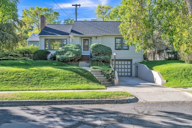 ranch-style home with a shingled roof, a garage, concrete driveway, and a front yard